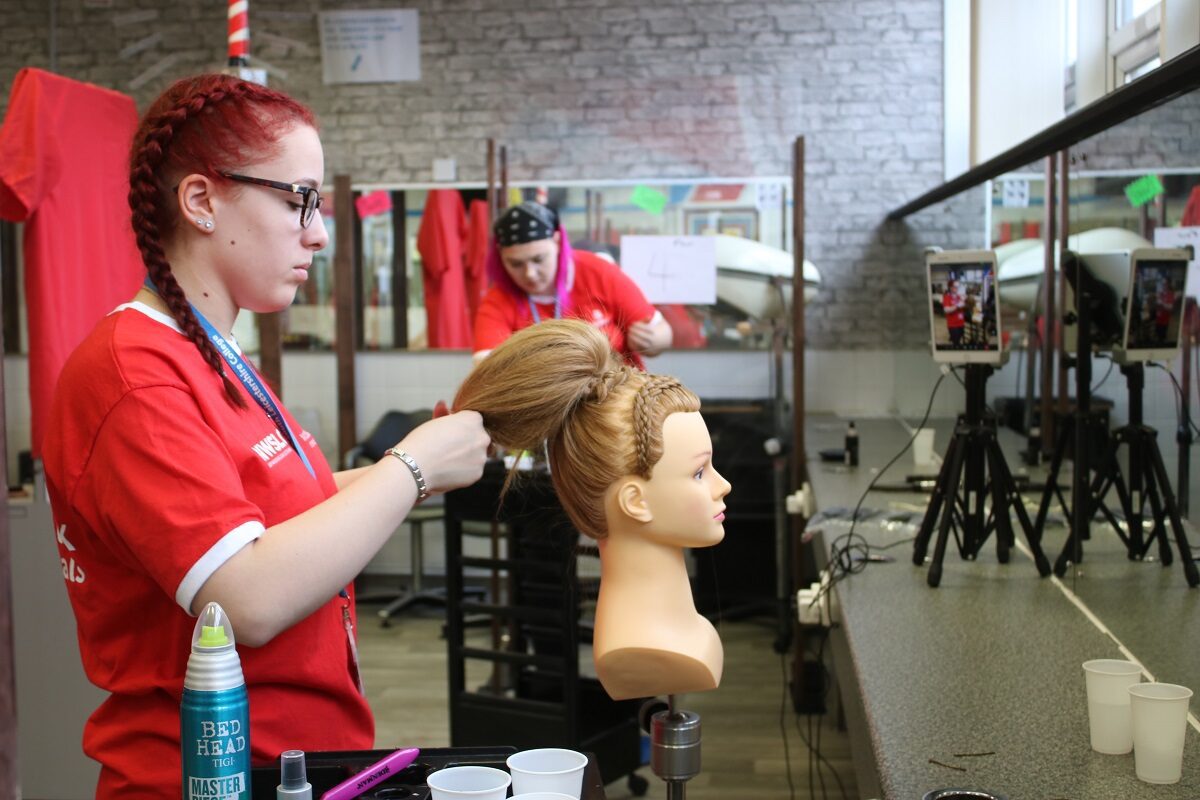 Student in salon practising hairdressing