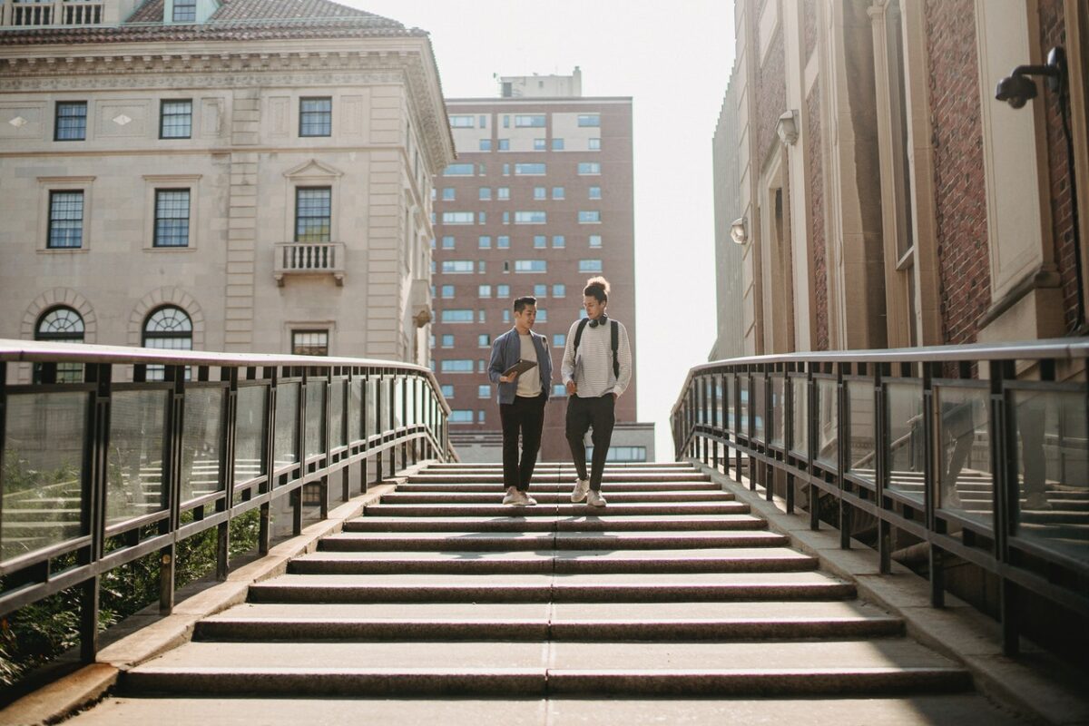 2 students stood on stairs