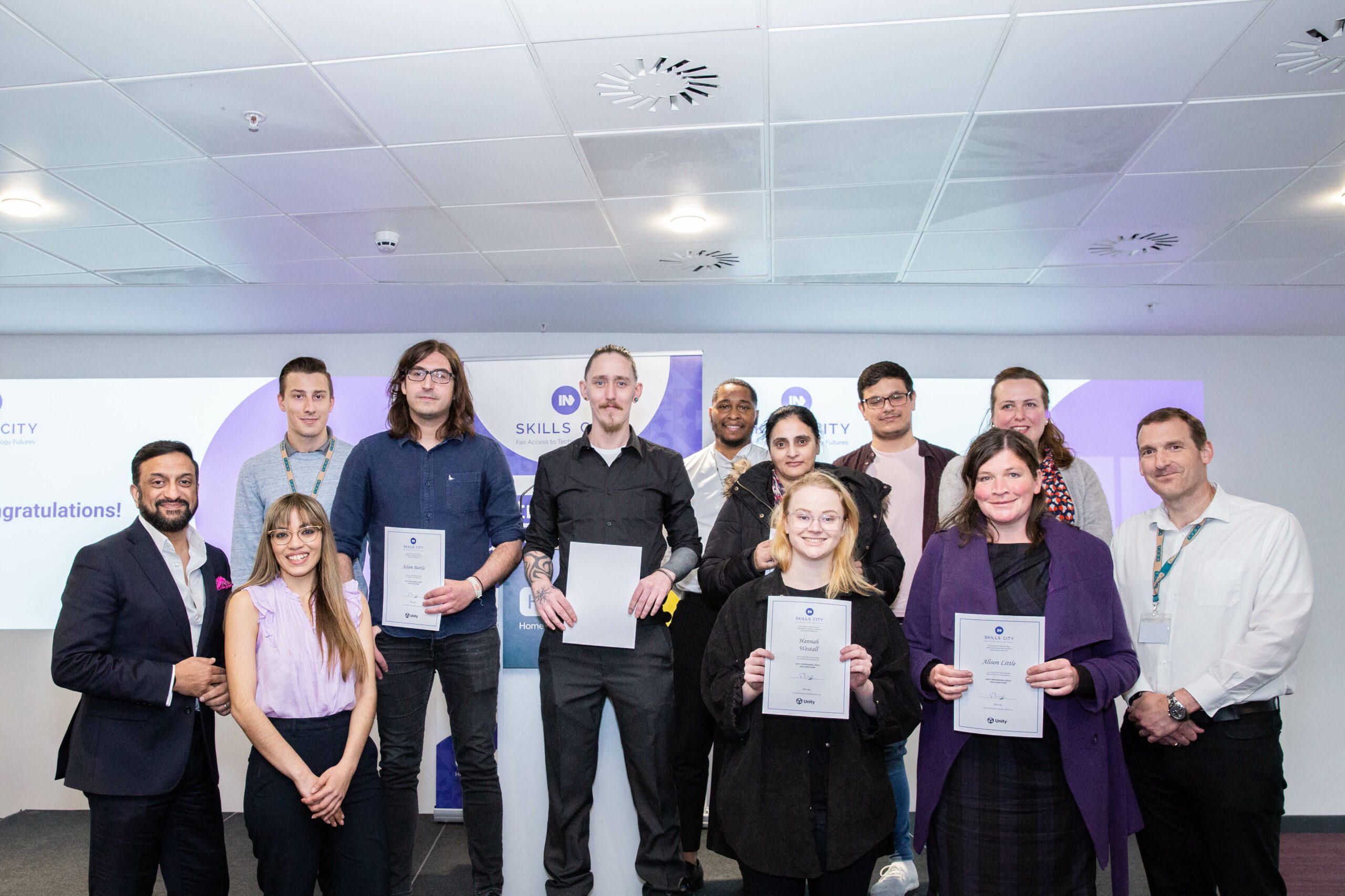 Skills City graduates with Mo Isap, CEO of IN4 Group on the far left and Simon Benson, Immersive Technology Director at IN4 Group on the far right).