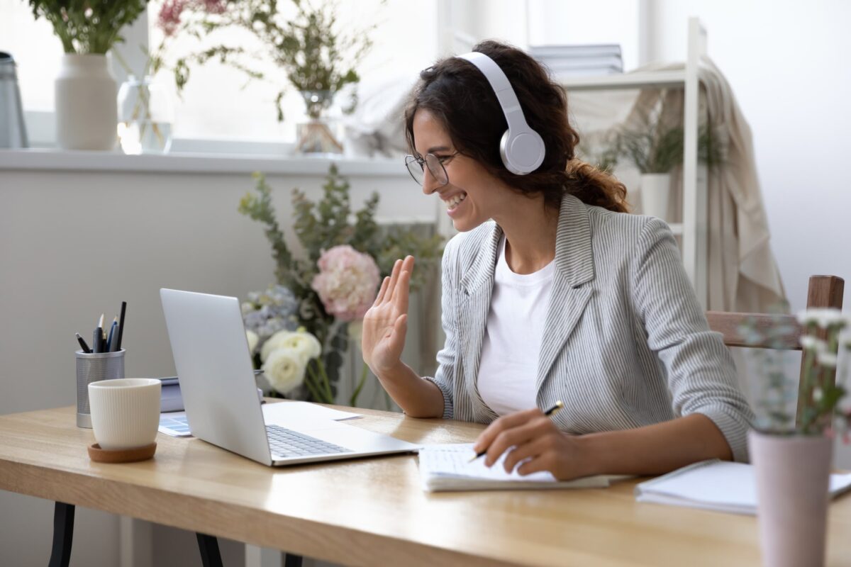 woman with headphones on looking at laptop