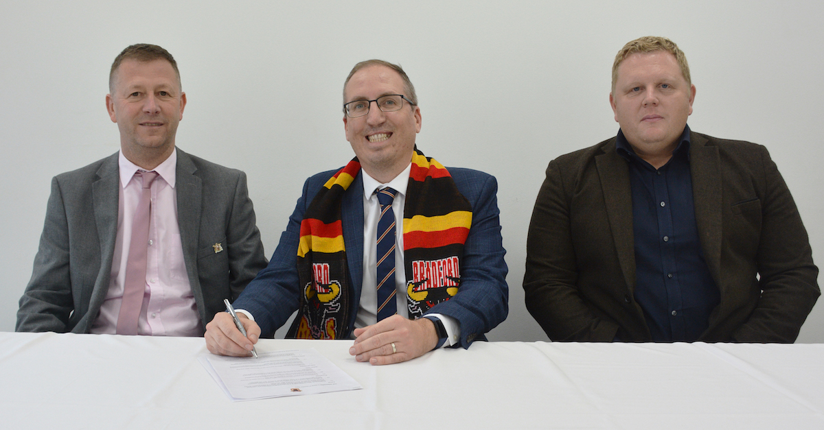 (L-R): Jason Hirst (CEO of Bradford Bulls), Christopher Malish (Vice Principal of Finance & Corporate Services at Bradford College), and Chris Chamberlain (Bradford Bulls Foundation CEO) sign the education partnership agreement at Odsal stadium.