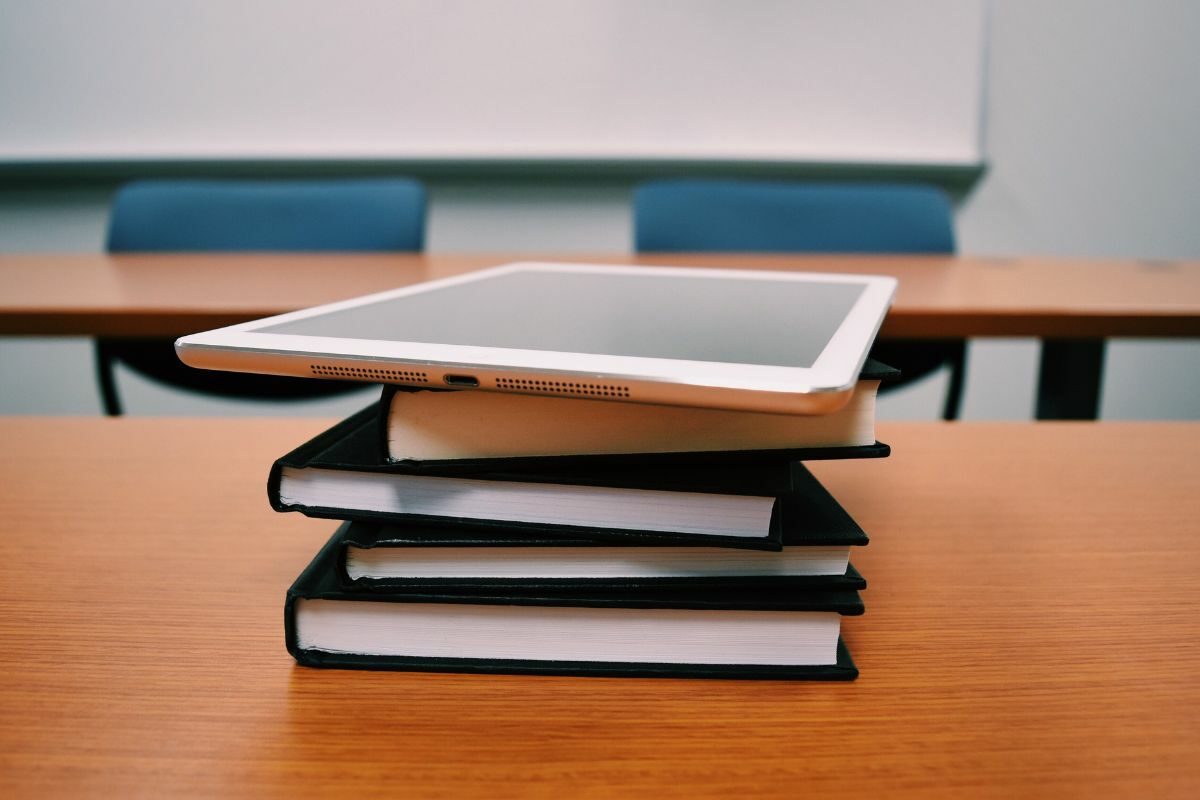 iPad on top of pile of books