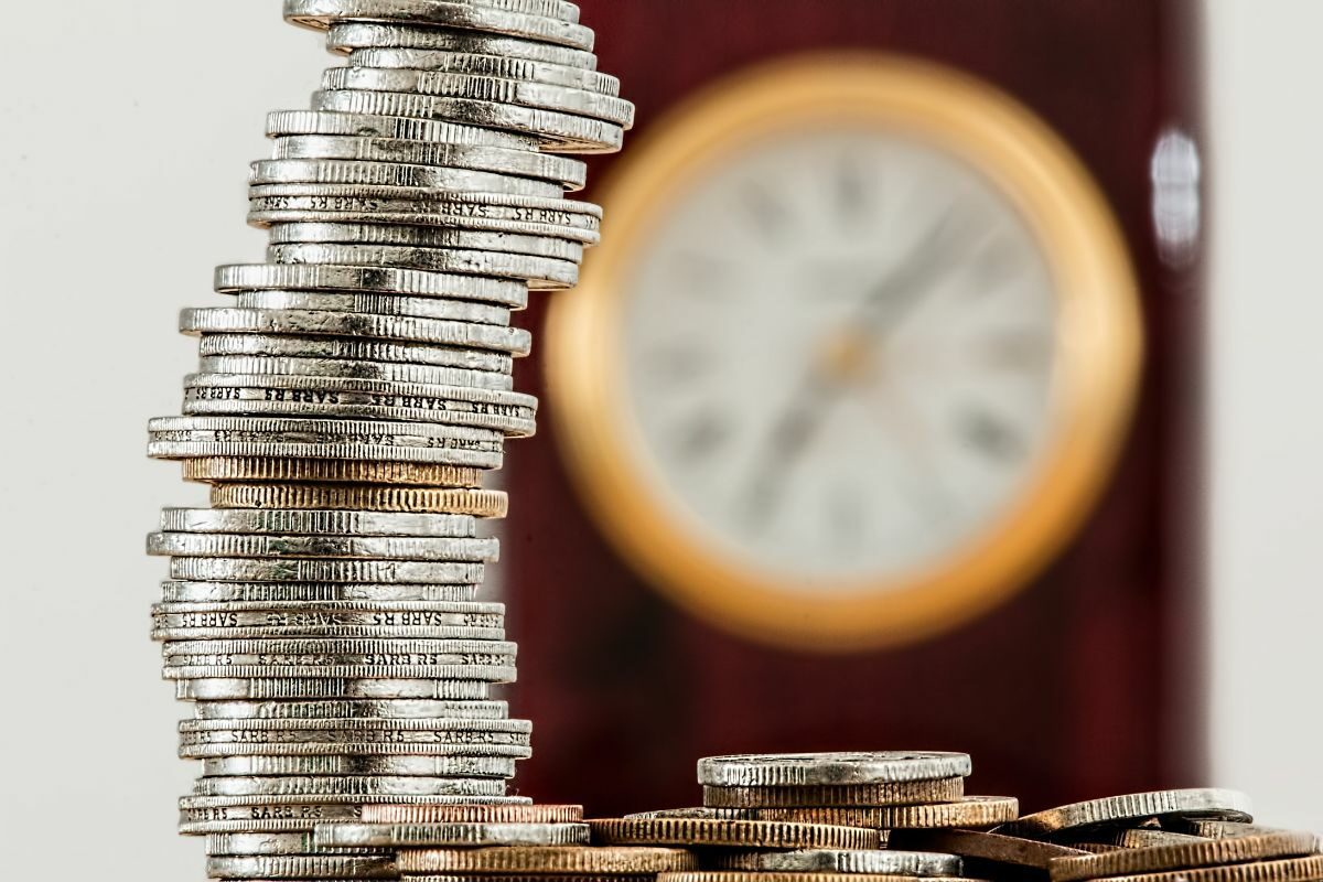 pile of coins and a clock