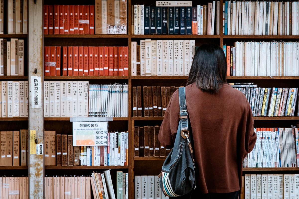 female stood at bookcase