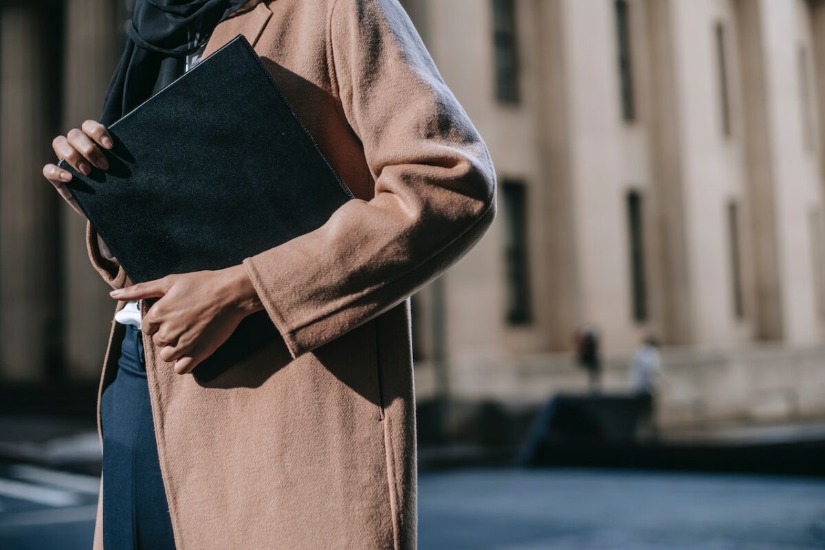 Person holding a black folder