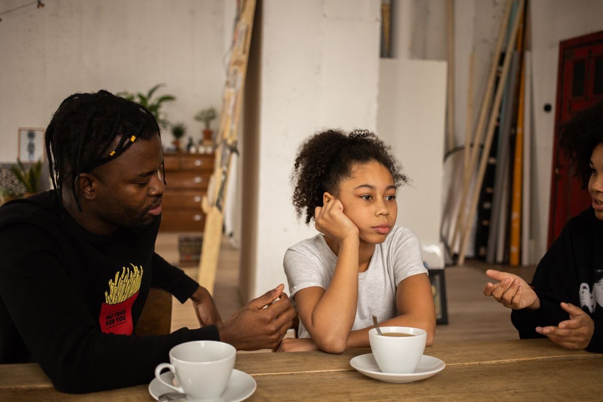 2 adults sat with child