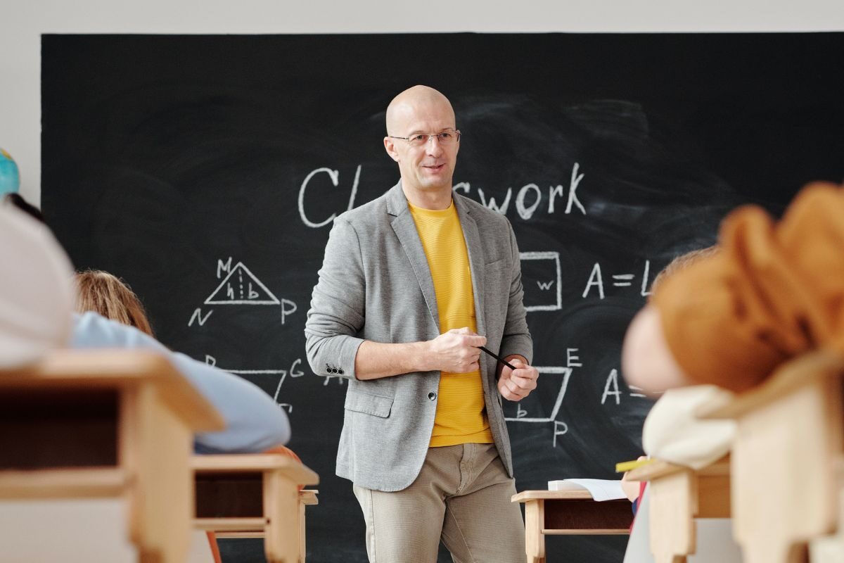 teacher stood in front of blackboard