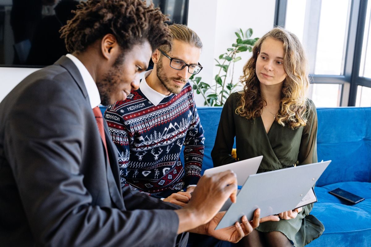 3 people looking at a piece of paper