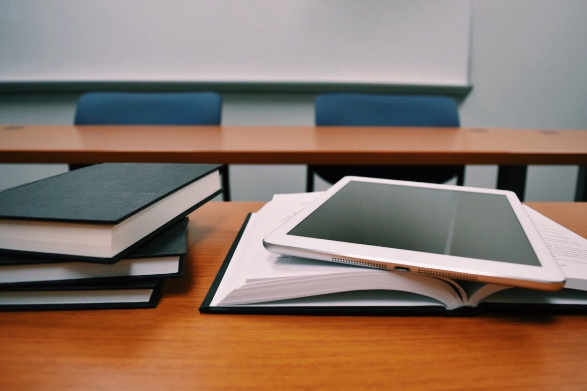 books and tablet on table