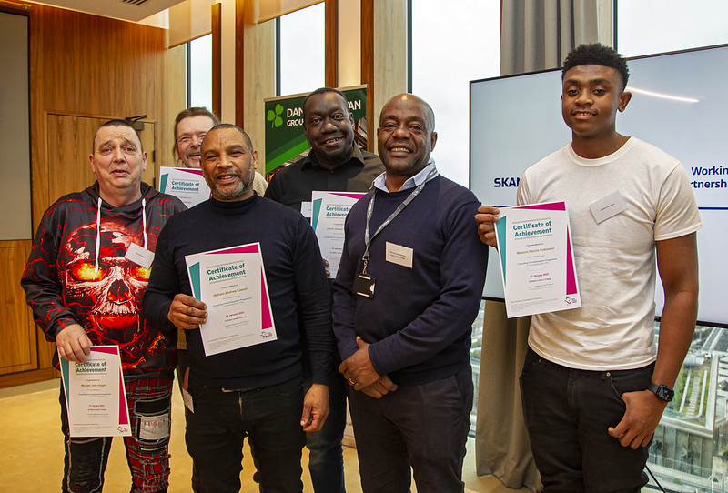 eacher Bernard Mayengehama (centre) and the 5 West London College Students at an HS2 celebratory graduation event 12 January 2023, following their paid work trial in the Lord Mayor’s Parlour, Westminster City Hall