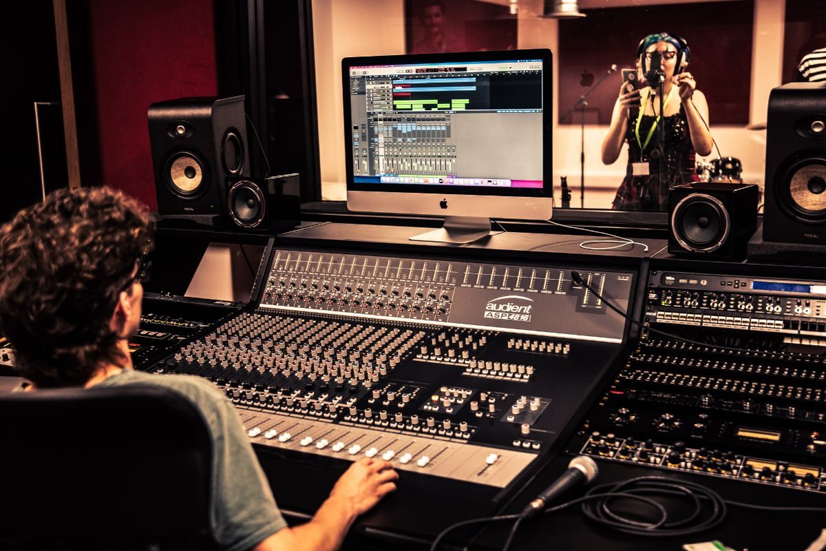 Man using studio level mixing desk