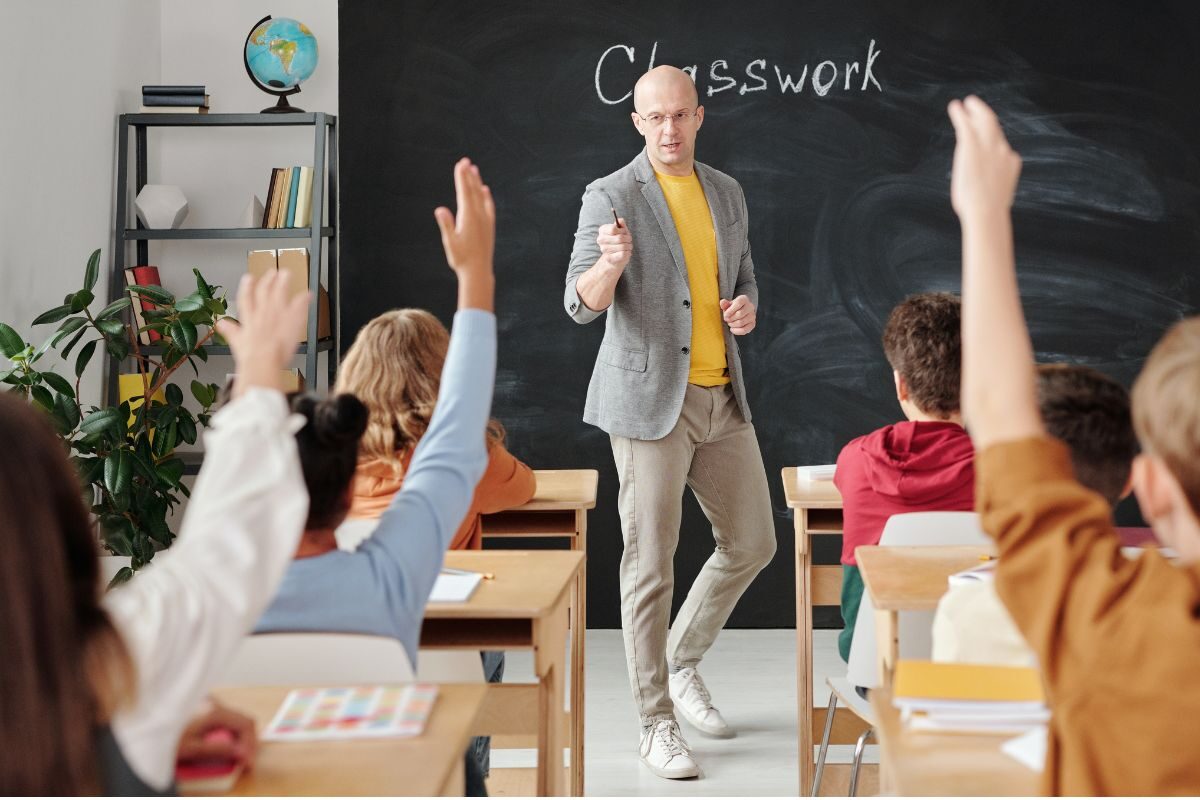 classroom with students' hands up