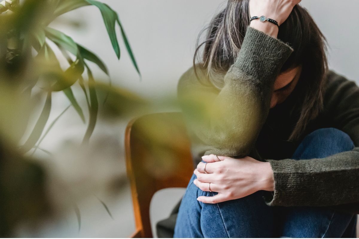 woman sat looking stressed