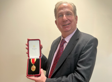 Sir Paul Phillips with his Knighthood medal