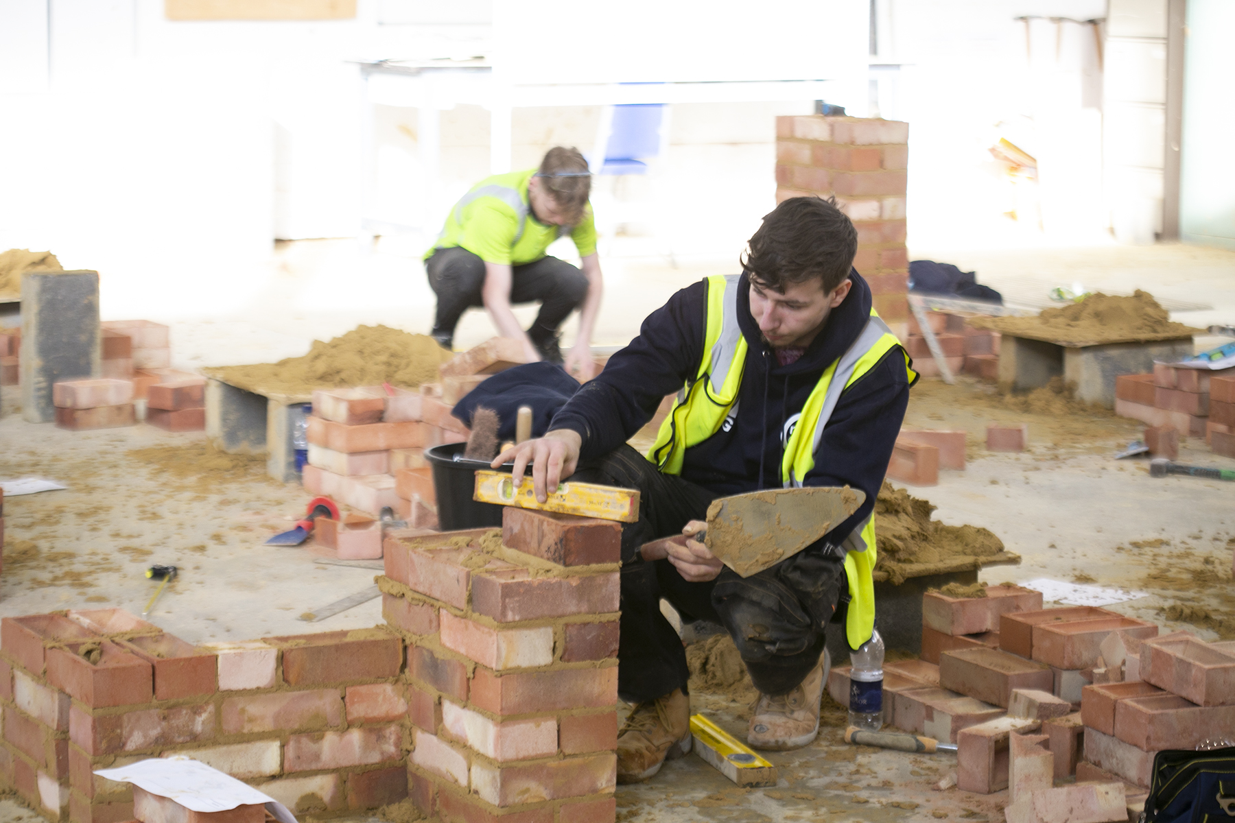 Image shows a student laying bricks as part of a skills competition.