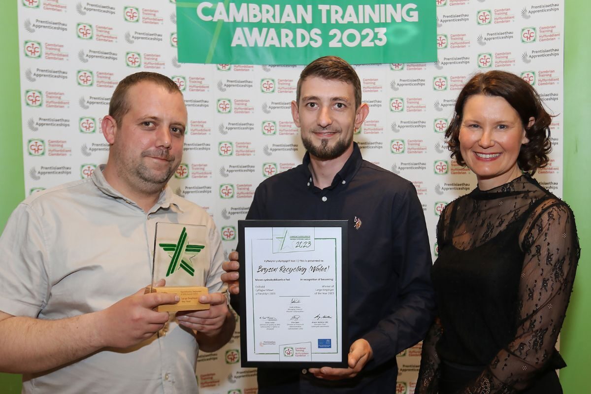 Bryson Recycling (Wales) General Manager Gareth Walsh (left) and Conwy Site Manager Dan McCabe receive the Large Employer of the Year award from Cambrian Training Company’s Managing Director Faith O’Brien.
