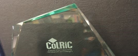 CoLRiC glass trophy with logo