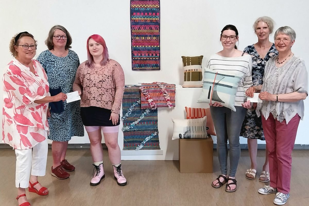 Kay-lee Davies and Jade Carey Holt display their work as they receive their bursaries from Wonderwool Wales directors Chrissie Menzies, Olwen Veevers and Sarah Stacey, watched by BA Textiles programme director at Carmarthen School of Art, Nia Lewis.