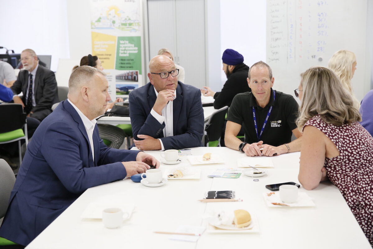 A group of four employers and Leeds College of Building staff sit around a table in a classroom and discuss the growing demand for green skills in construction.