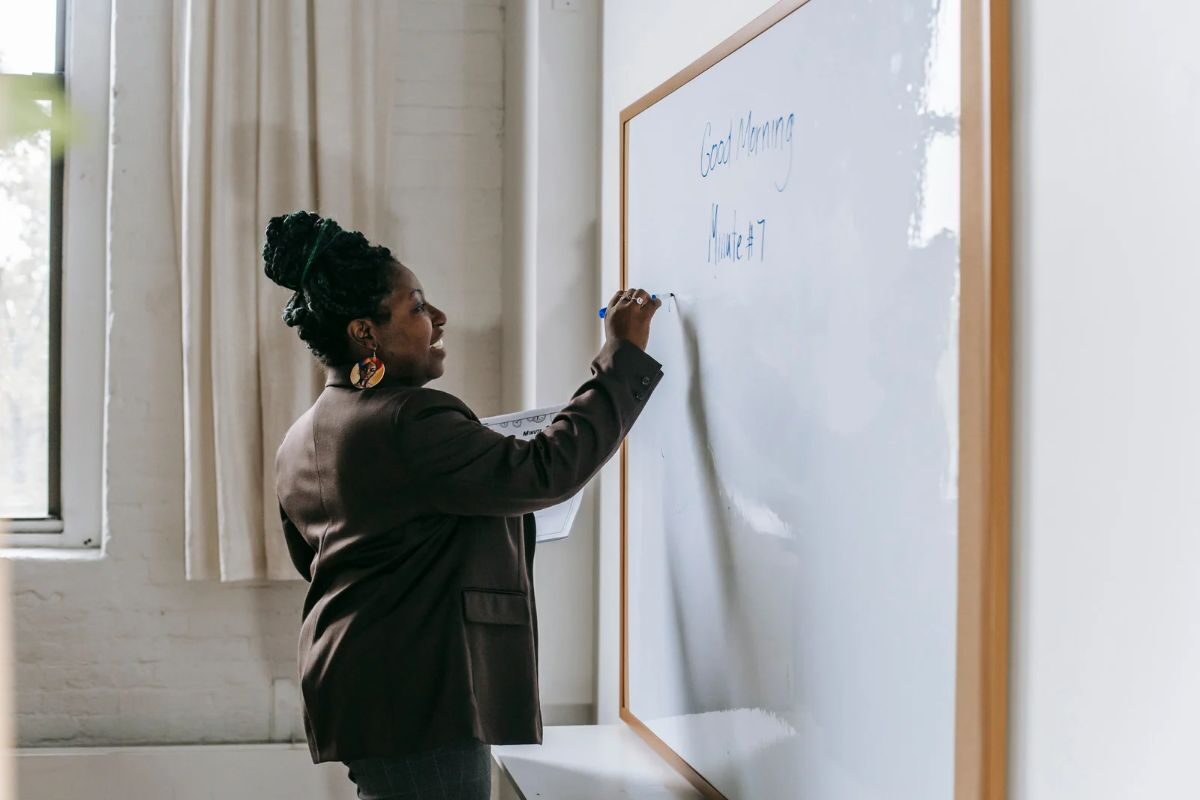 woman writing on whiteboard