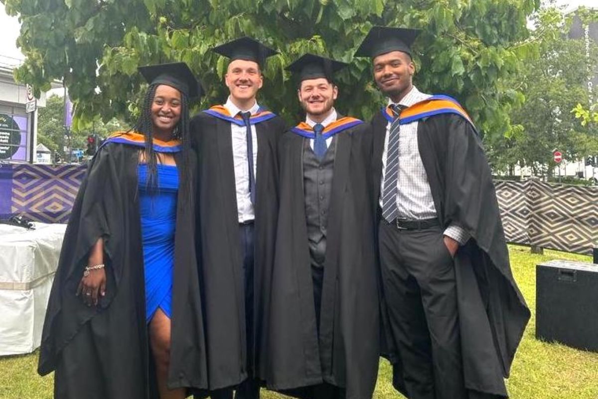 Four Leeds College of Building BSc (Hons) Civil Engineering Site Management degree apprentices pose outside in their cap and gown.