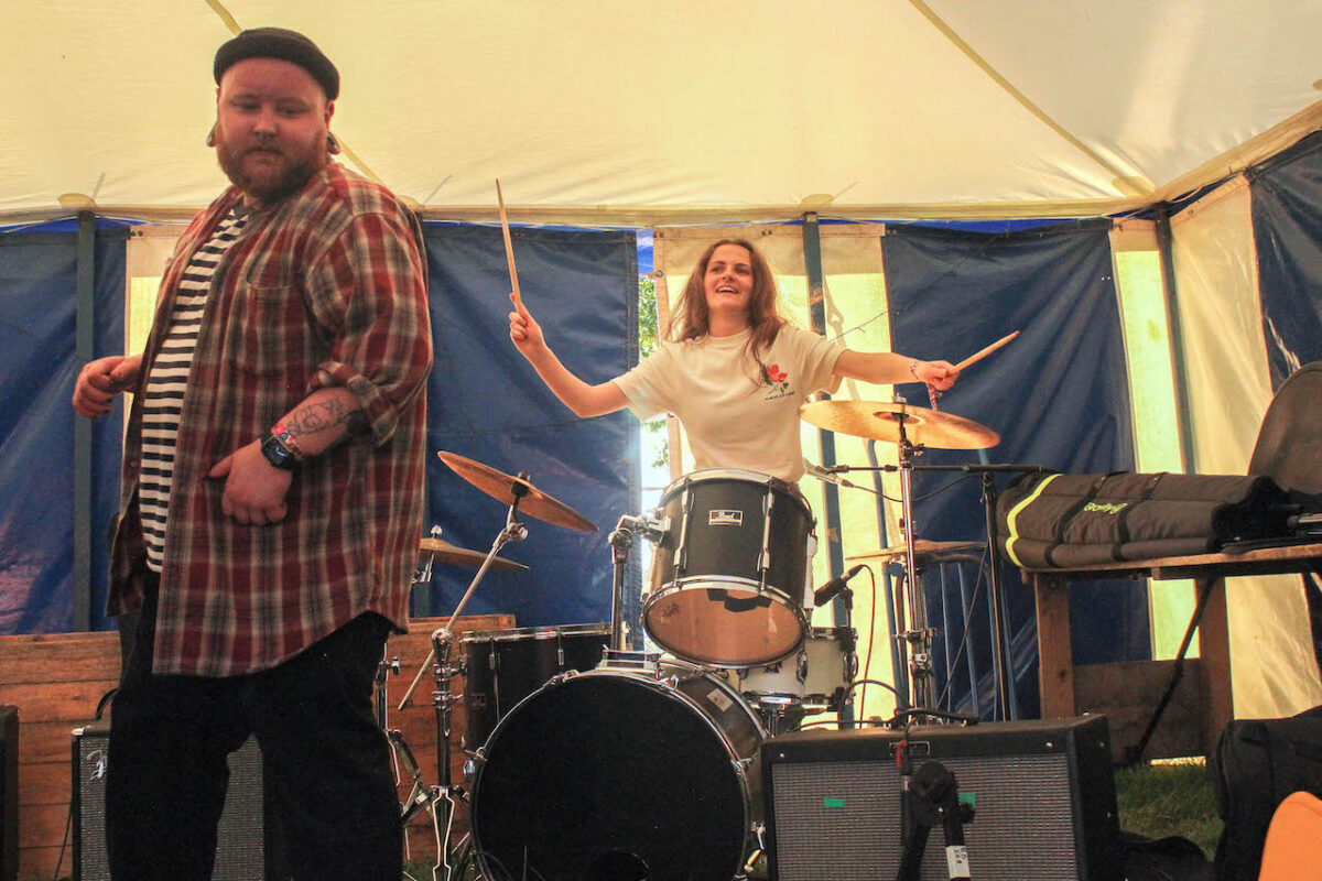 A female student drummer performs in a tent at the Deershed festival.