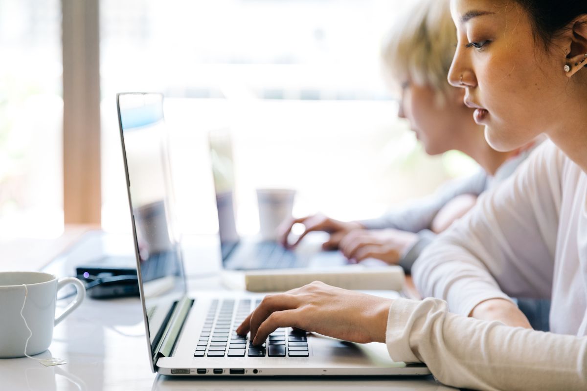 Asian lady researching on laptop