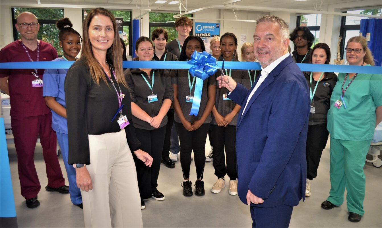 Simon Whitehouse cuts the ribbon to open the new centre at Telford College, watched by Sarah Davies and college health students