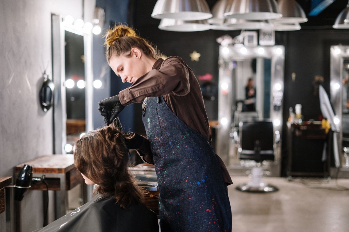 woman cutting a womans hair