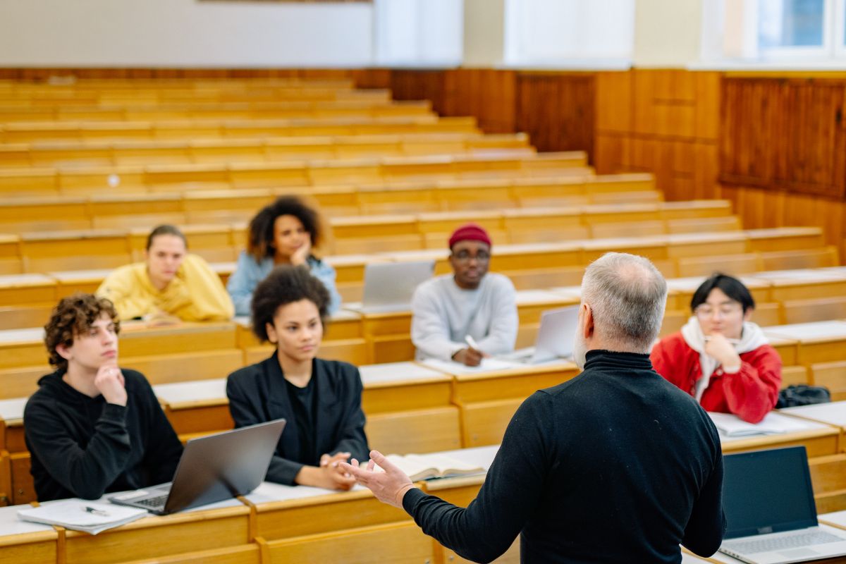 teacher teaching a small class in a big room