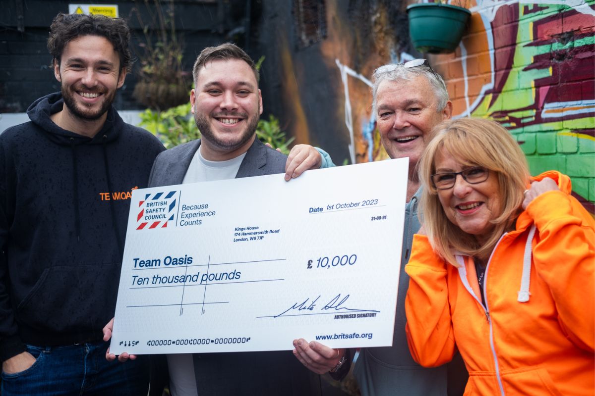 Team Oasis CEO and Founder, Paul Nilson (centre right) receives their Keep Thriving award from Matthew Stainer, Strategic Account Manager at British Safety Council (centre left), with James Nilson, Fundraiser at Team Oasis (left), and Julie Nilson (right).