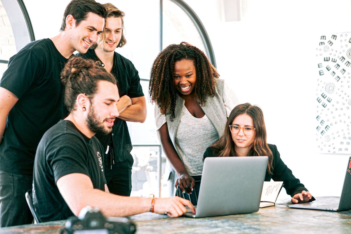 group gathered around a computer