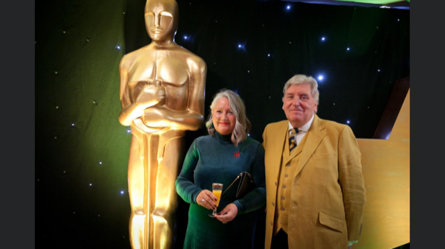 Ann Isherwood and husband smiling for a photo at the Redditch Business Awards