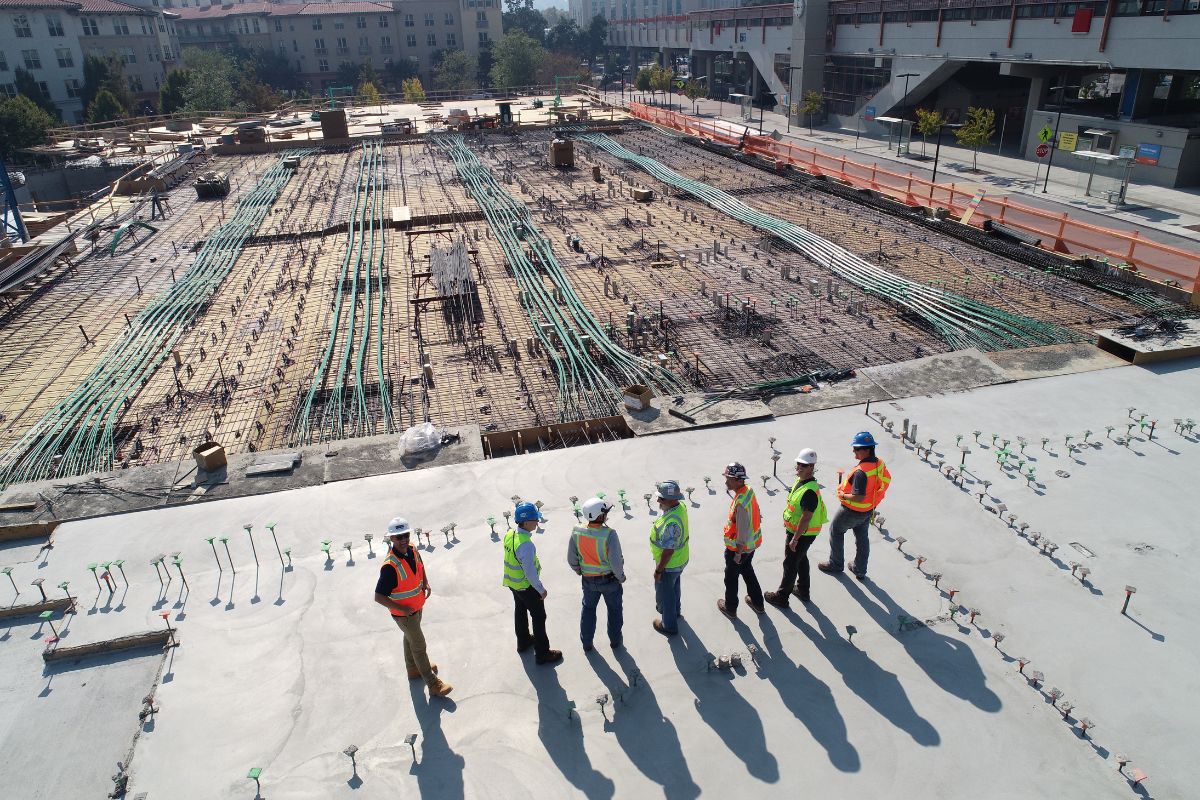 6 engineers stood on a roof of construction site