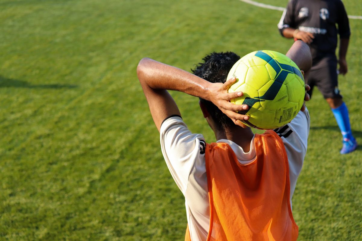 kid throwing a football