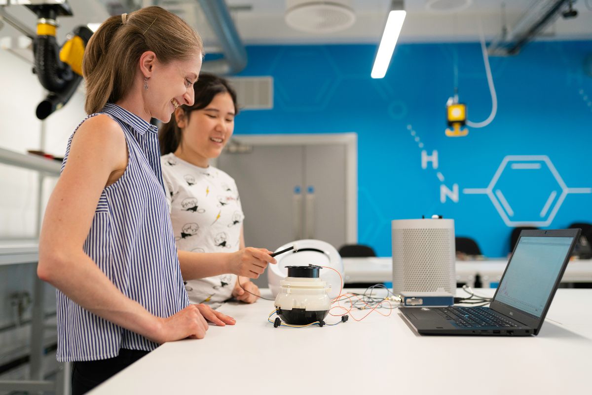 female teacher and student doing science experiment