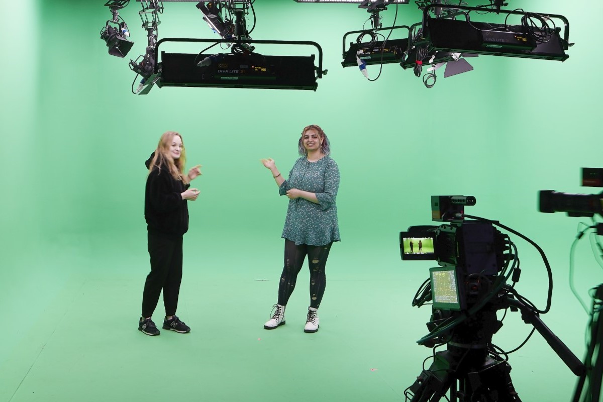 Students use motion tracked cameras in green screen studio