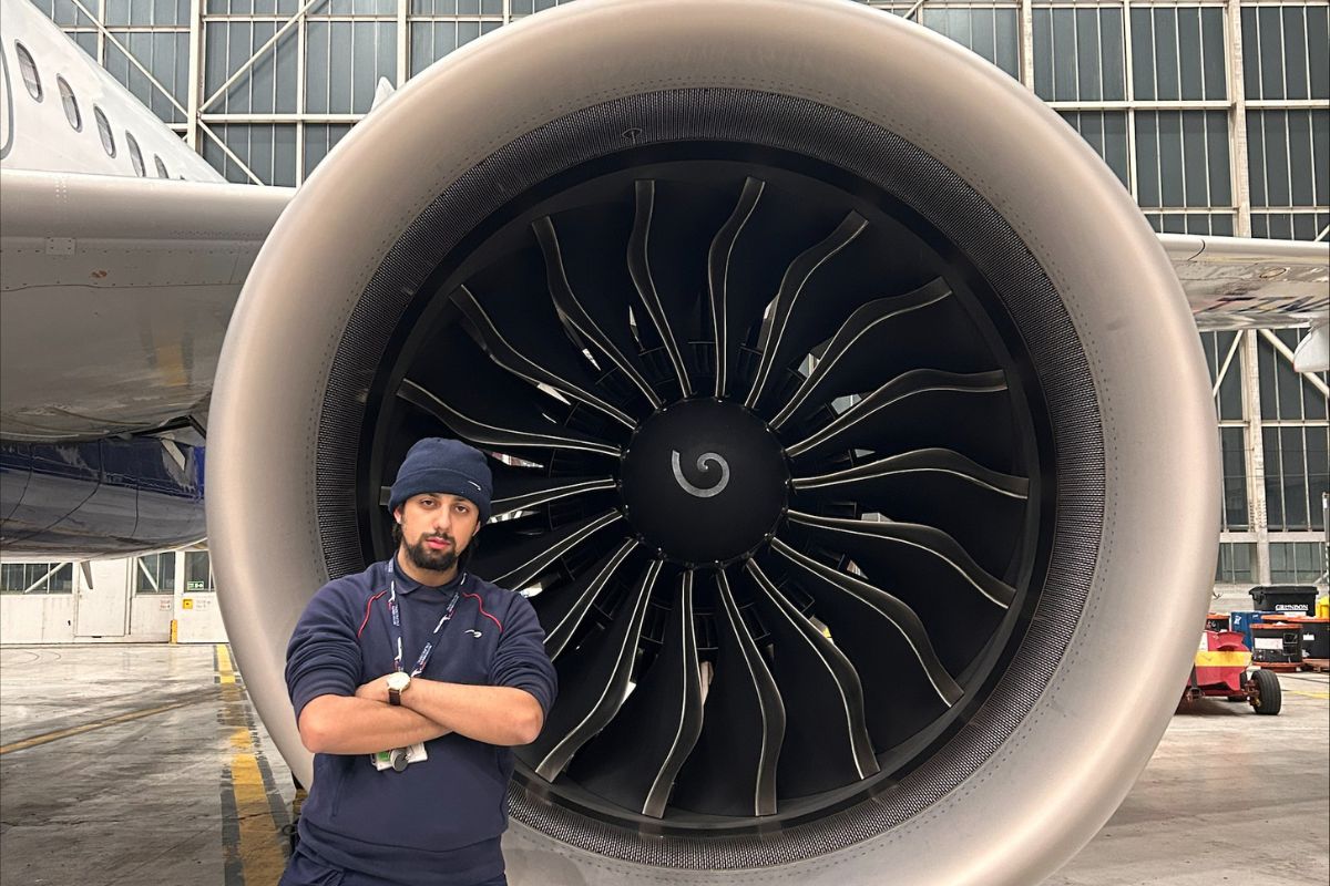 male apprentice stood in front of aeroplane