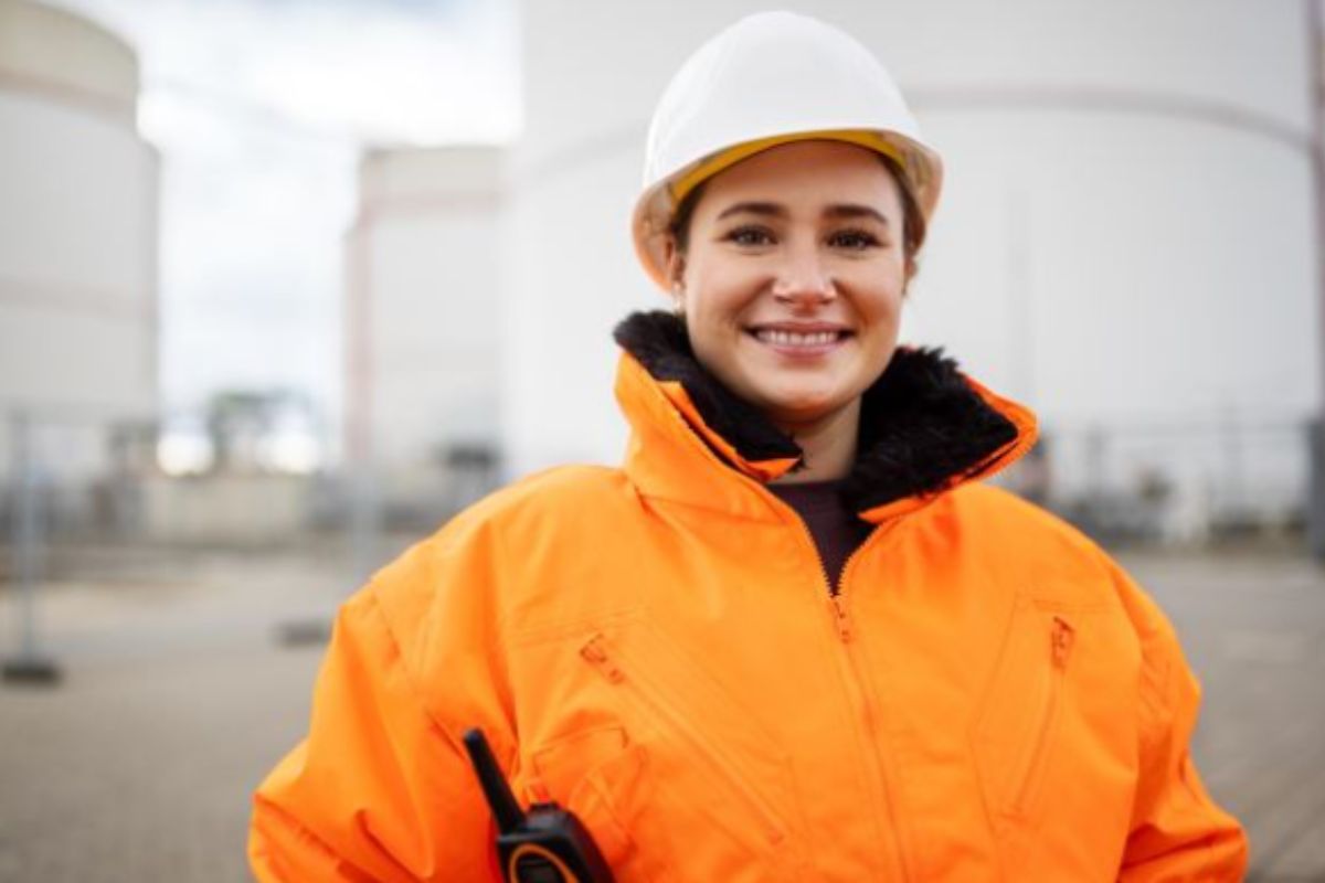 women in fluorescent jacket and white hard hat