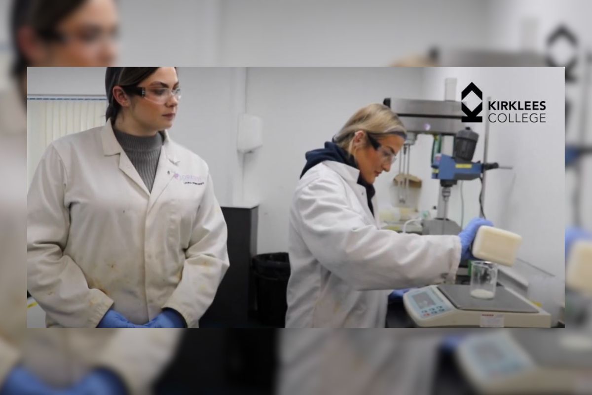 Two women in lab coats working with laboratory equipment