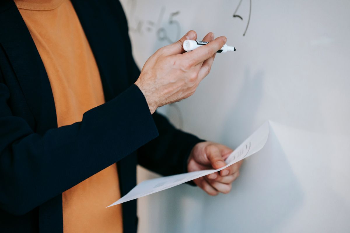 teacher writing on whiteboard