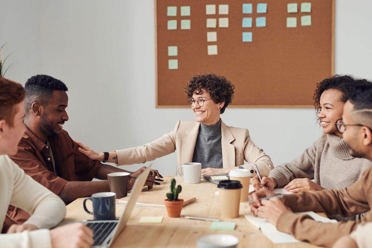 people in a meeting laughing