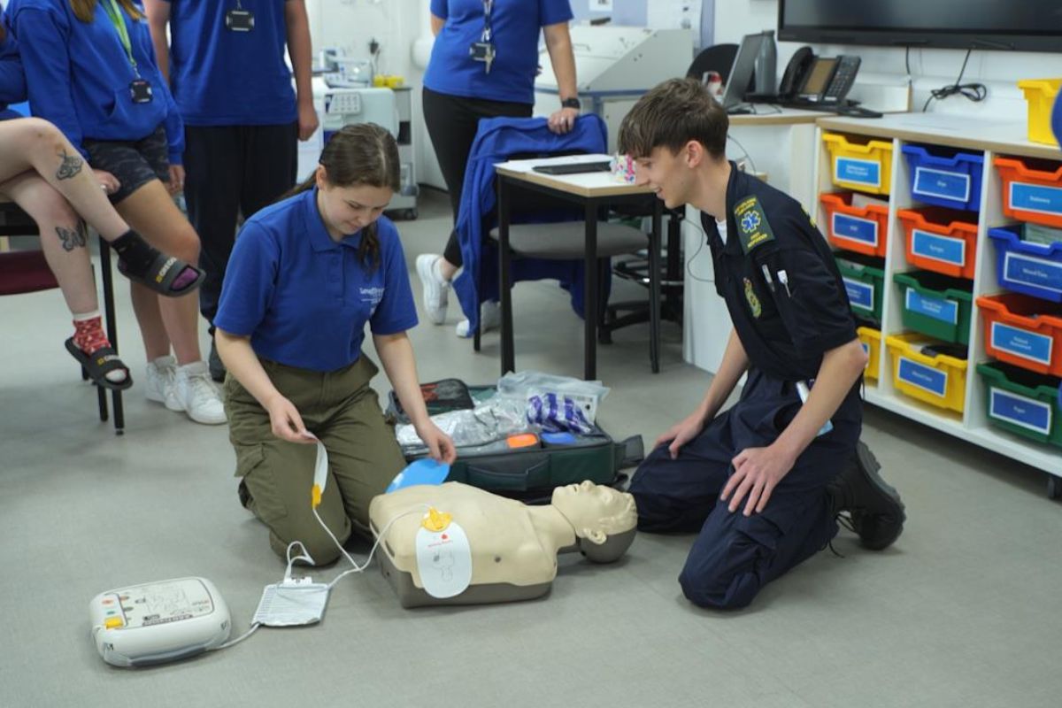 students working on a dummy
