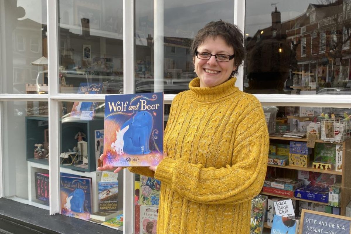 Women showing off her colouring book Wolf and Bear