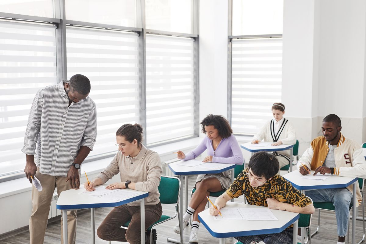 students sat on individual tables with a piece of paper each