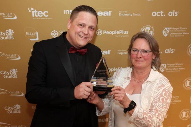 Adam Bagwell from Transport for Wales receives the Large Employer of the Year award from Bridget Moseley, head of apprenticeships at University Wales Trinity Saint David, sponsor.