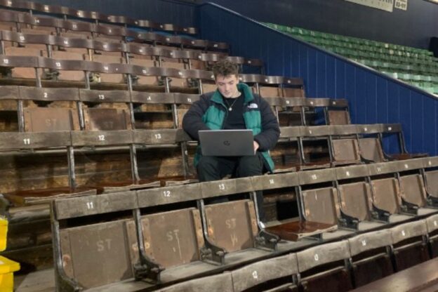 student sat in a football stadium