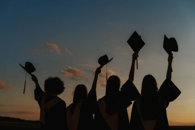 Graduates waving hats in the air, Pexels stock