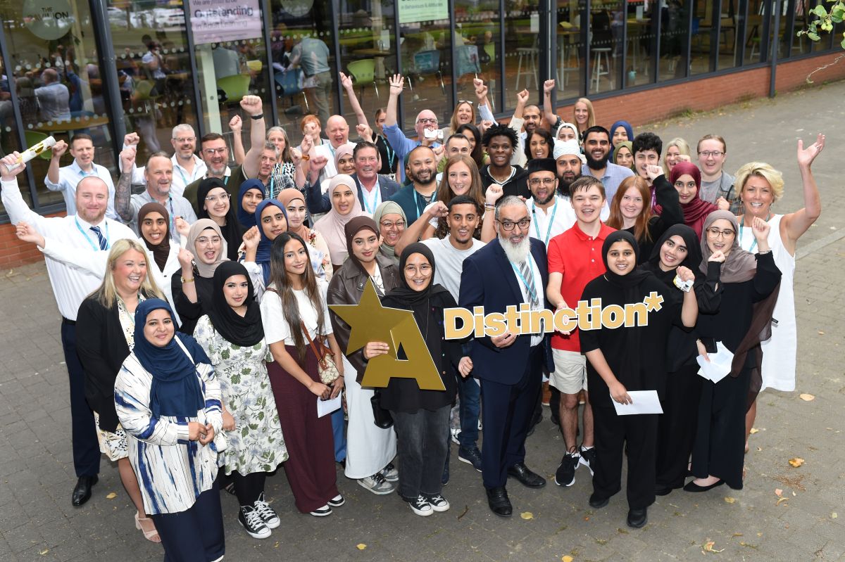 Blackburn College staff and students celebrating results day with Principal Dr Fazal Dad
