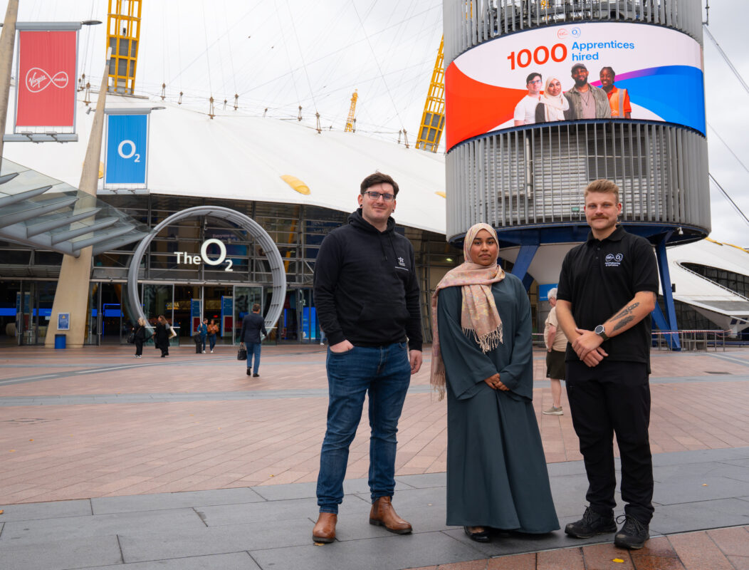 Virgin Media O2 apprentices stand outside London's O2 Arena to mark the company hiring it's 1000th apprentice